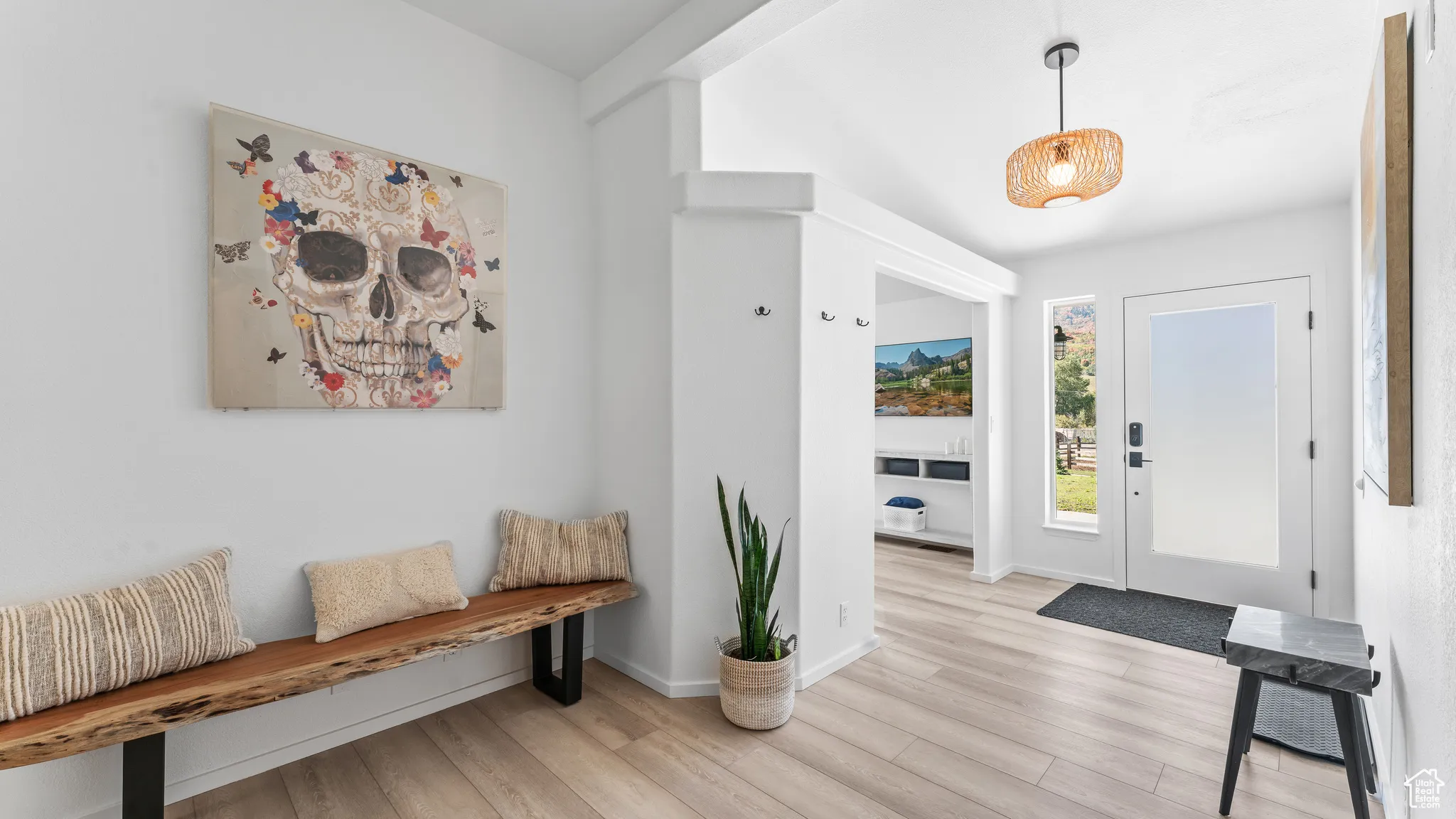 Entrance foyer featuring light wood-style flooring and baseboards
