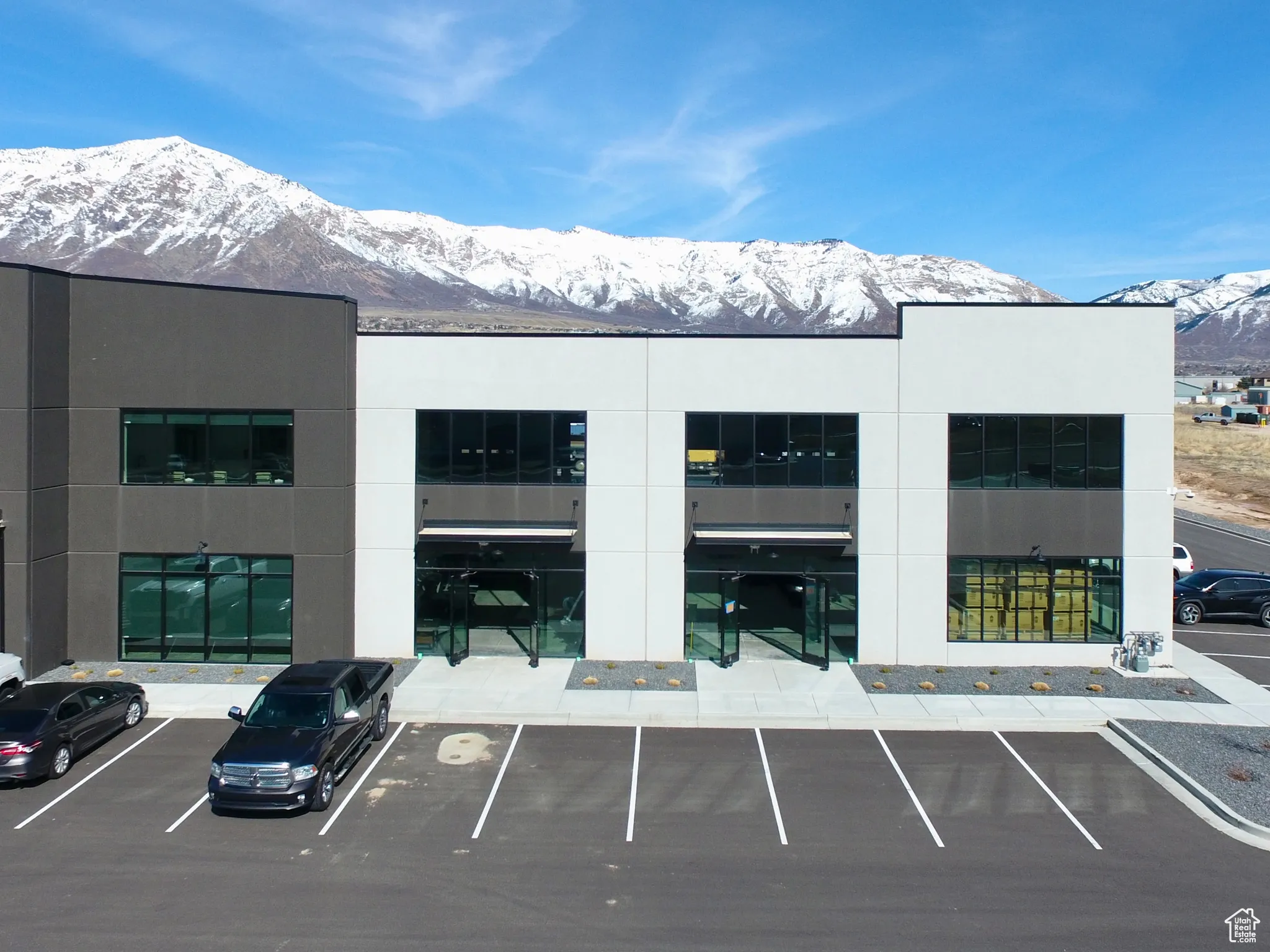View of property with uncovered parking and a mountain view