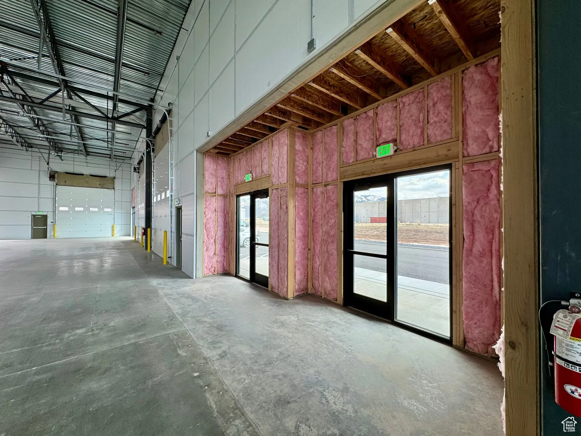 Misc room featuring unfinished concrete flooring and a garage