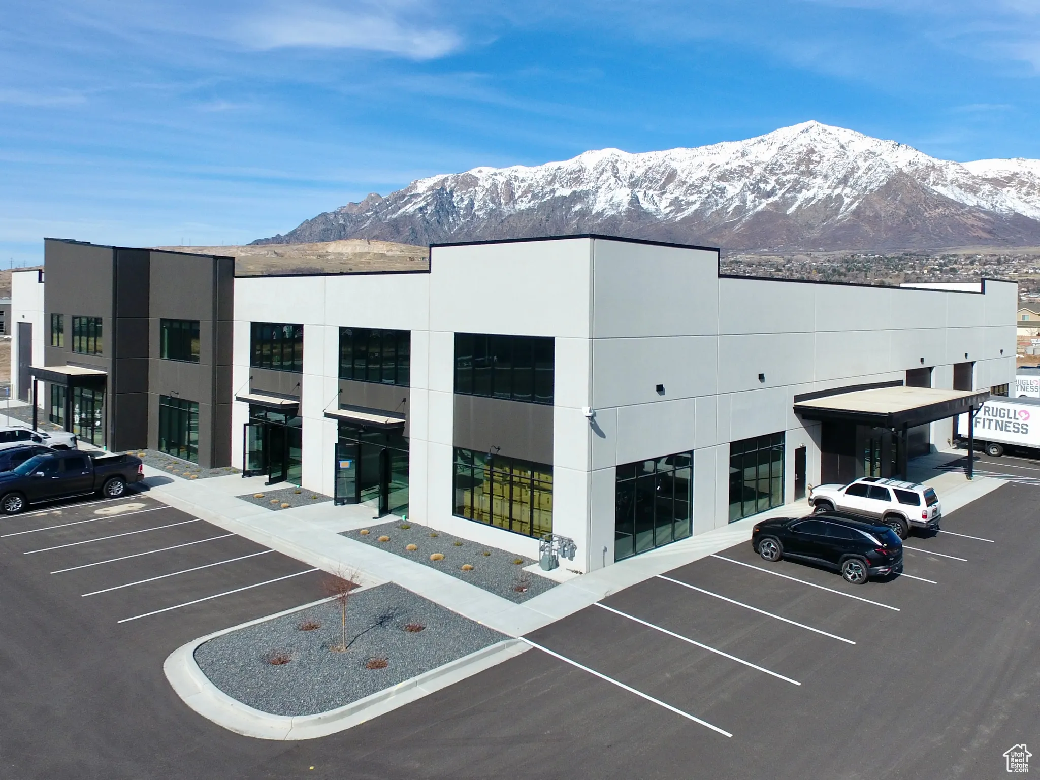 View of property featuring a mountain view and uncovered parking