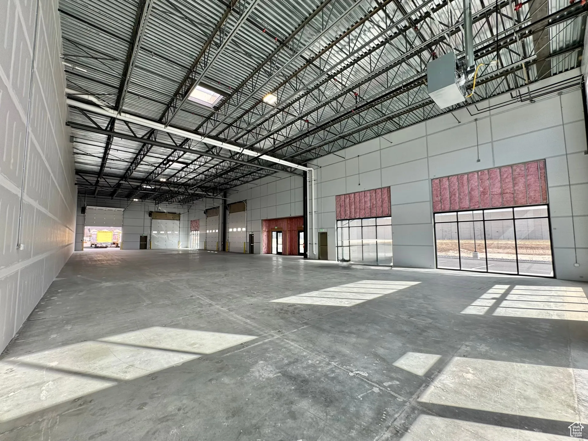 Garage featuring a garage door opener and metal wall