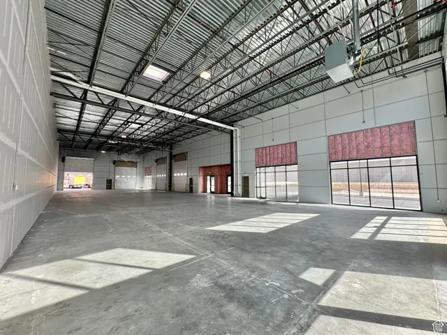 Garage featuring a garage door opener and metal wall