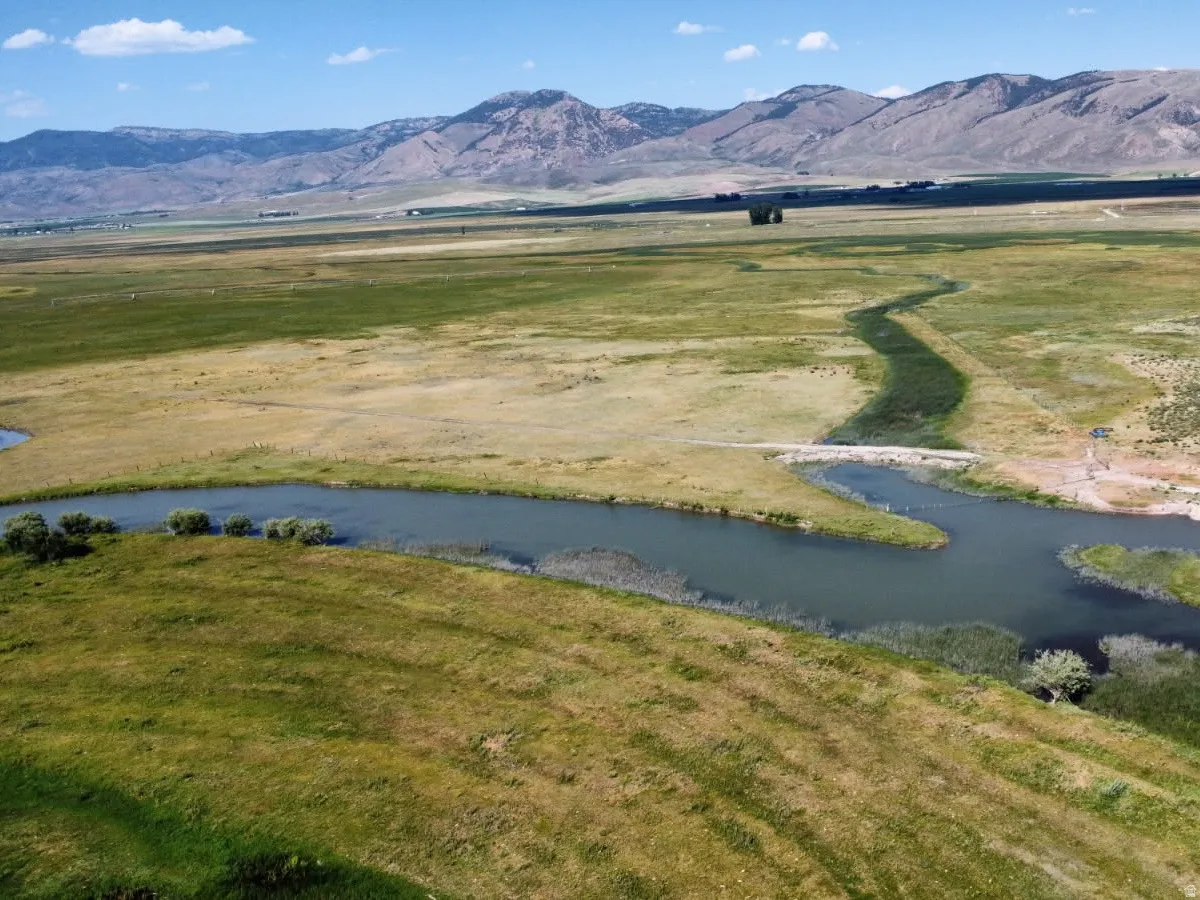Mountain view featuring a nearby body of water and rural landscape