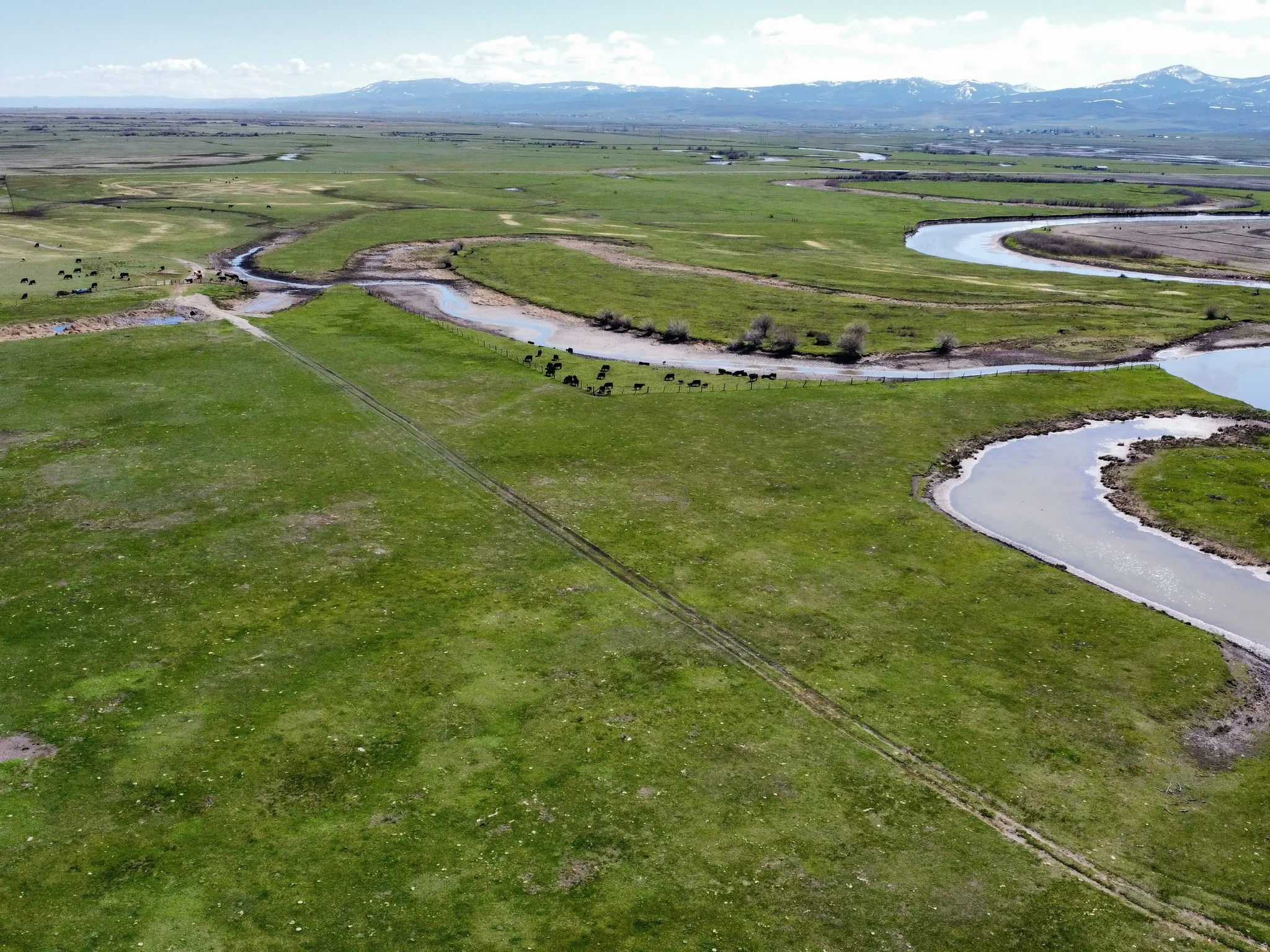 Aerial view of property and surrounding area with a mountainous background and rural landscape