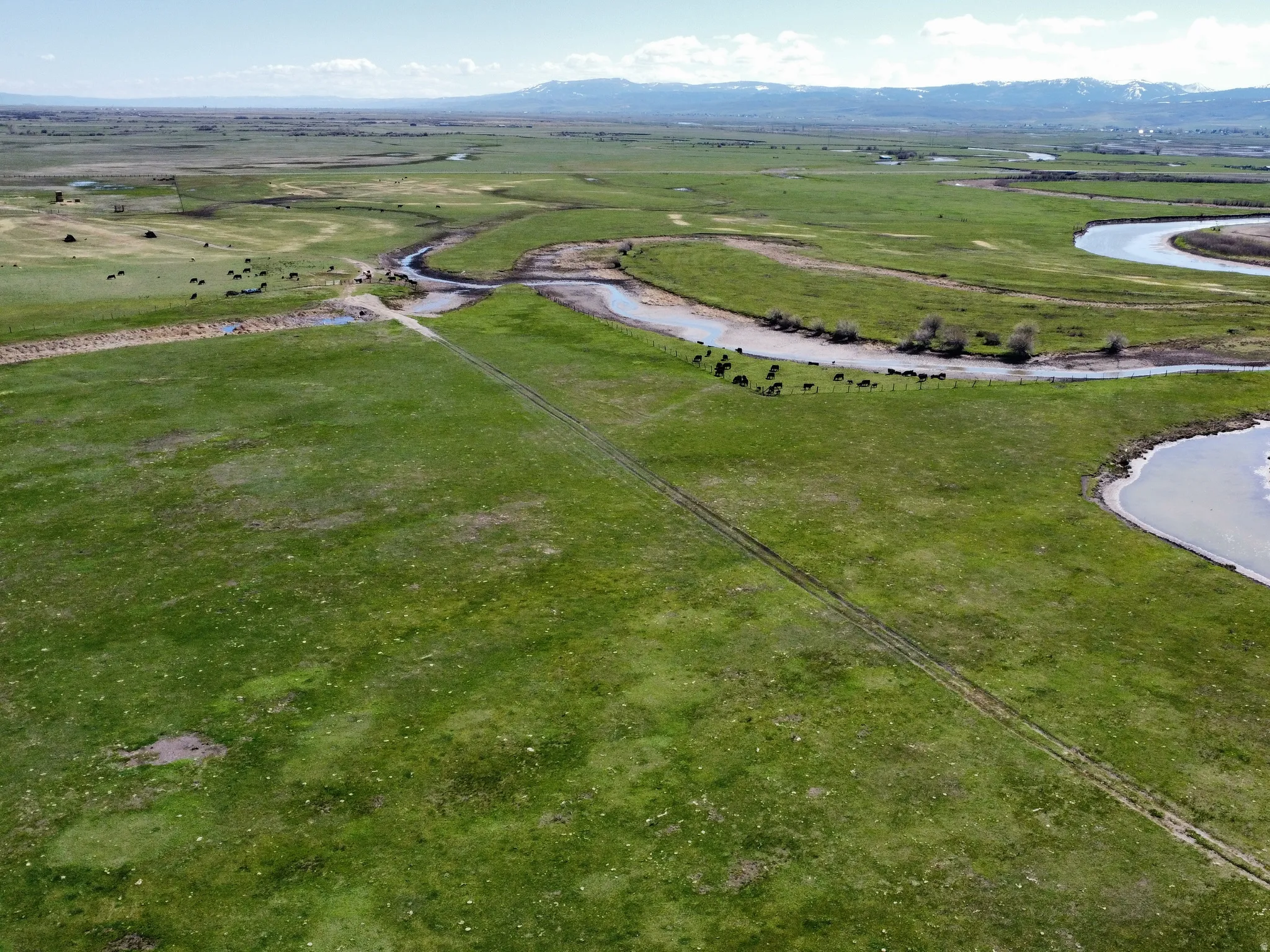 Aerial view of property and surrounding area with a mountainous background and rural landscape