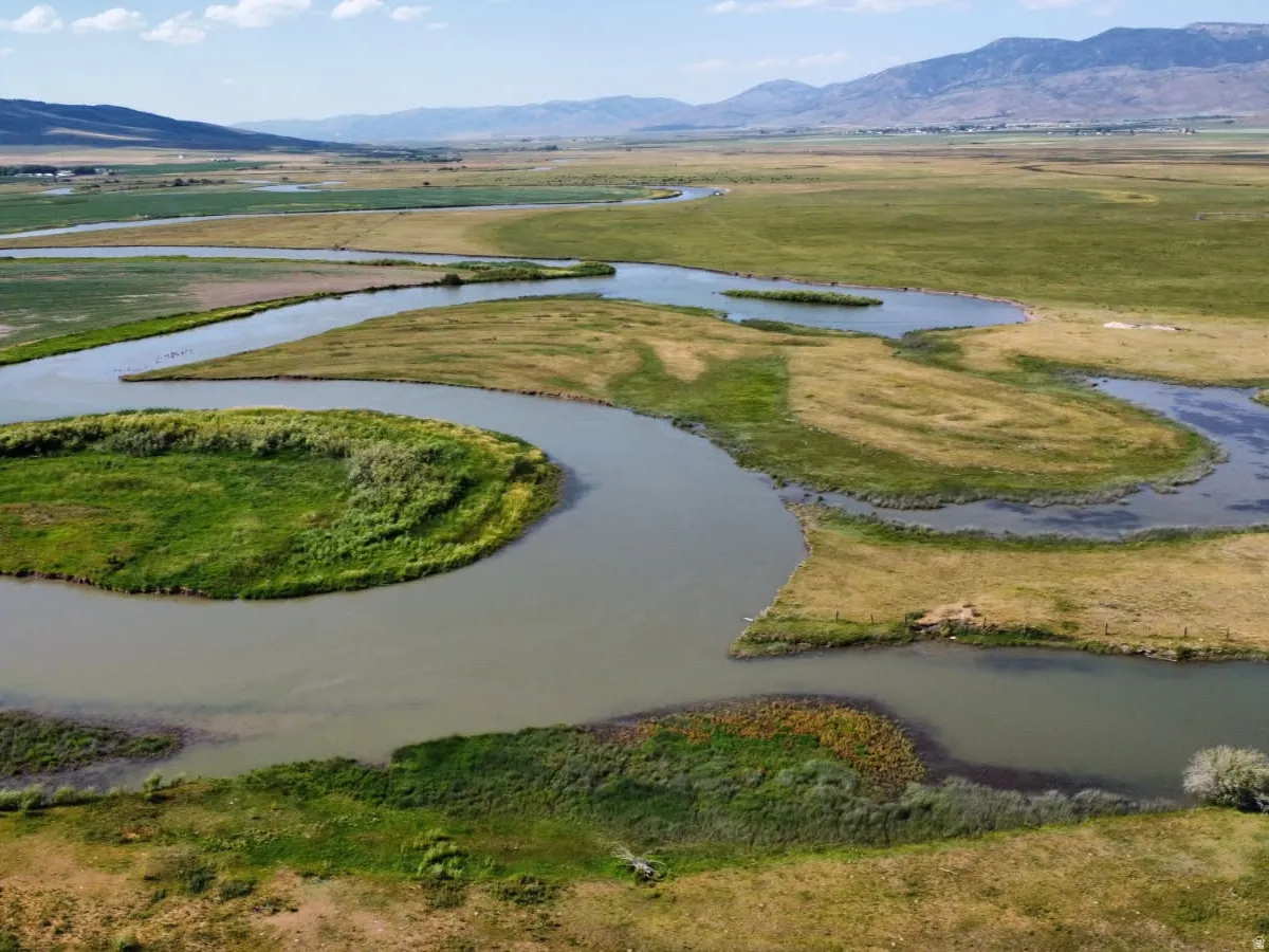 Aerial view of property's location with a water and mountain view