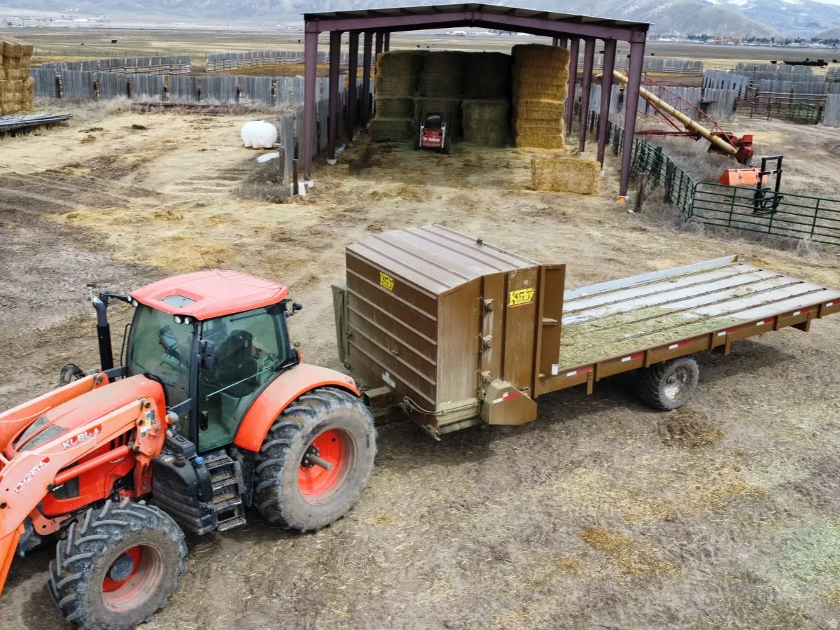 Exterior space featuring a rural view, fence, a mountain view, and an outbuilding