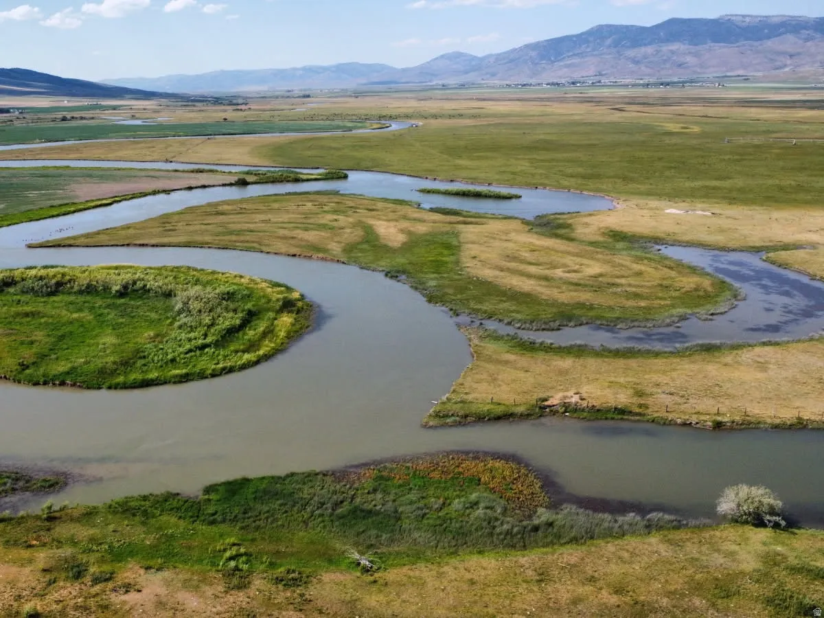 Aerial view of property's location with a water and mountain view