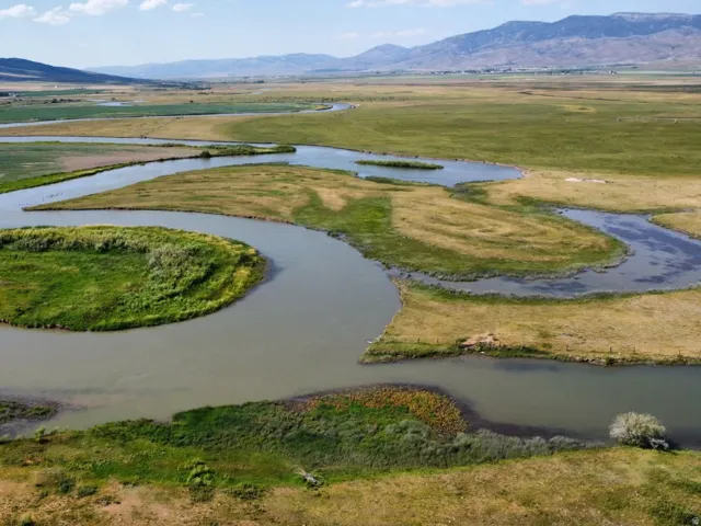 Aerial view of property's location with a water and mountain view