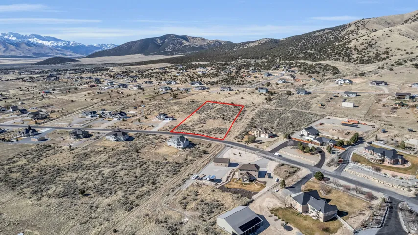 Birds eye view of property with view of desert and a mountain view