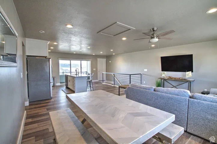 Dining space featuring dark wood finished floors, attic access, and recessed lighting