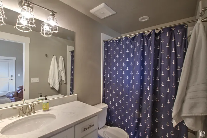 Full bathroom featuring, connected bathroom, toilet, and vanity
