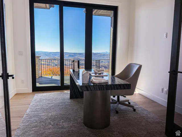 Office area featuring light wood finished floors and a mountain view