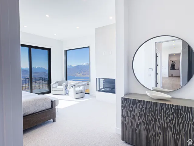 Bedroom with carpet floors, recessed lighting, and a mountain view