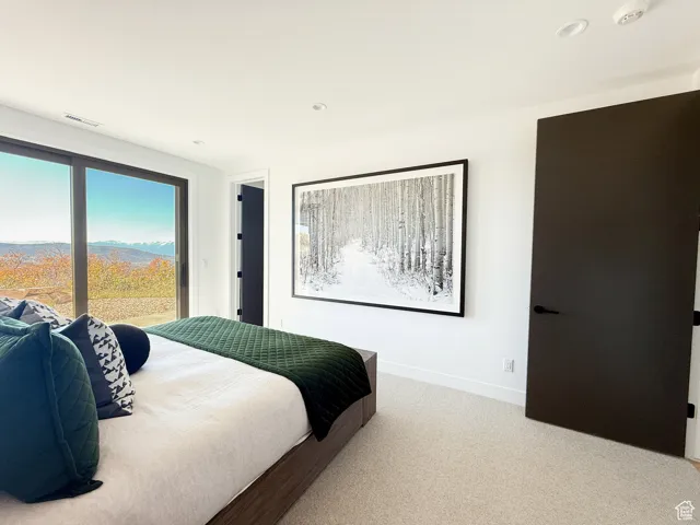 Carpeted bedroom featuring access to exterior, a mountain view, and recessed lighting