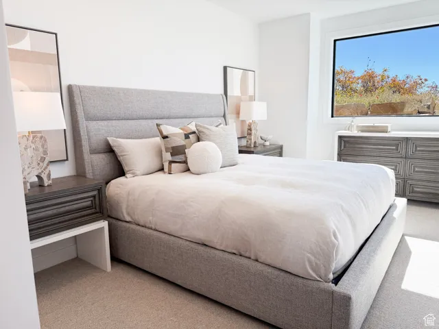 Bedroom with light colored carpet