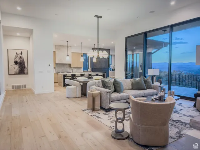 Living area with a mountain view, light wood-style floors, and recessed lighting