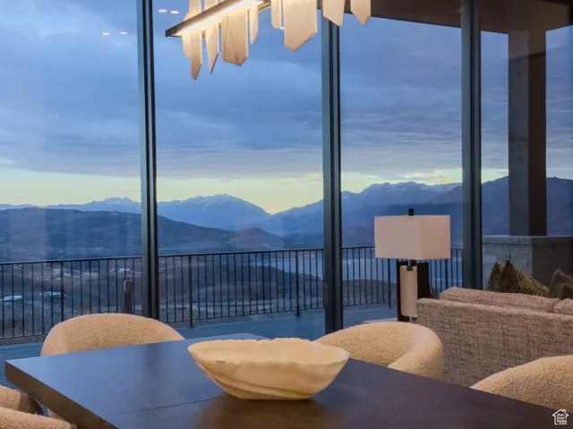 Dining room featuring a mountain view and a wall of windows