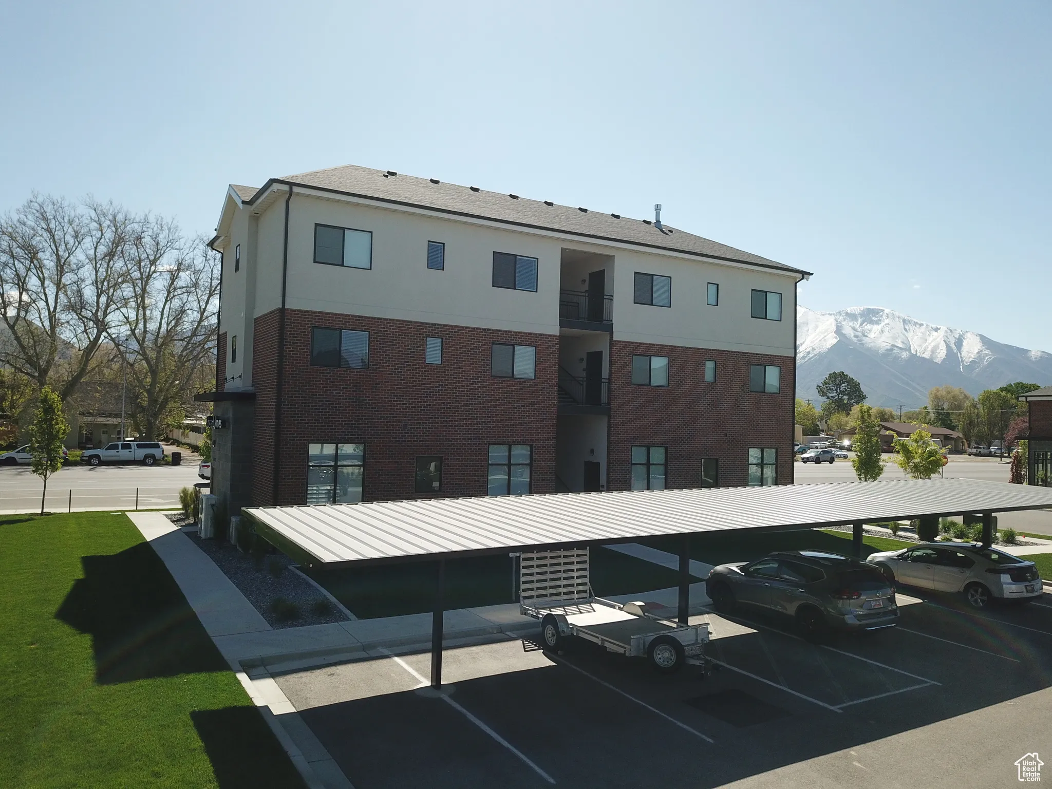 Exterior space with a mountain view and covered and uncovered parking