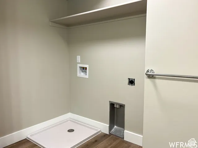 Laundry room with dark wood-style floors, electric dryer hookup, hookup for a washing machine, and laundry area