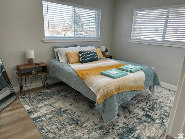Bedroom featuring baseboards and wood finished floors