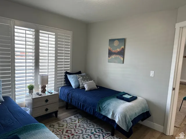 Bedroom with baseboards and wood finished floors