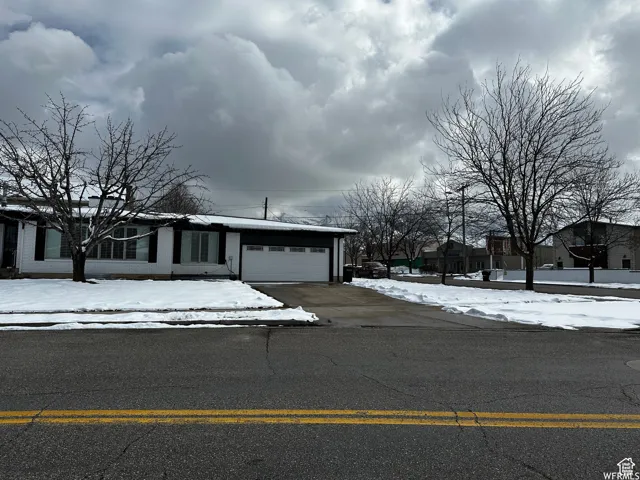 View of front of home with driveway and a garage
