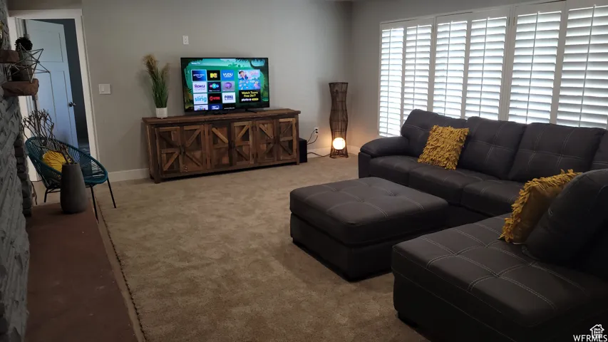 Carpeted living area with baseboards