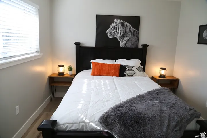 Bedroom featuring baseboards and wood finished floors