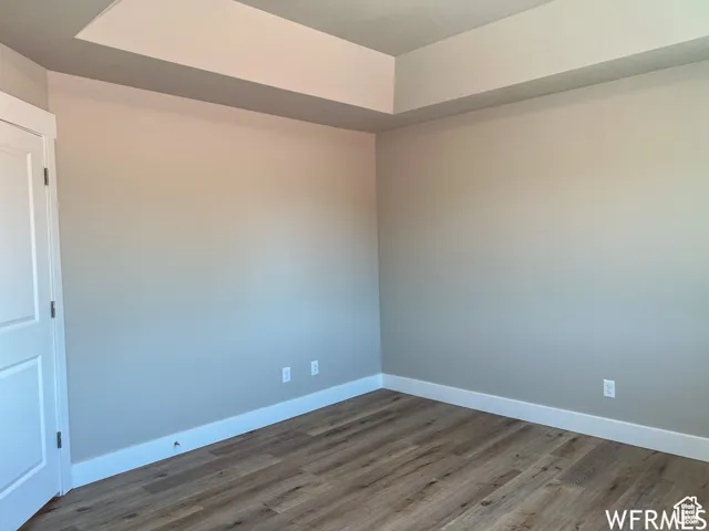 Empty room featuring baseboards and wood finished floors