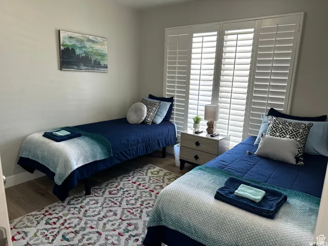 Bedroom featuring baseboards and wood finished floors