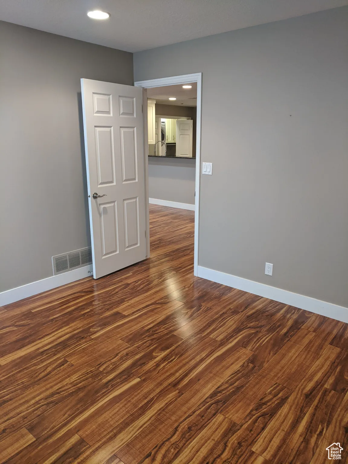Spare room with baseboards, visible vents, recessed lighting, and dark wood finished floors