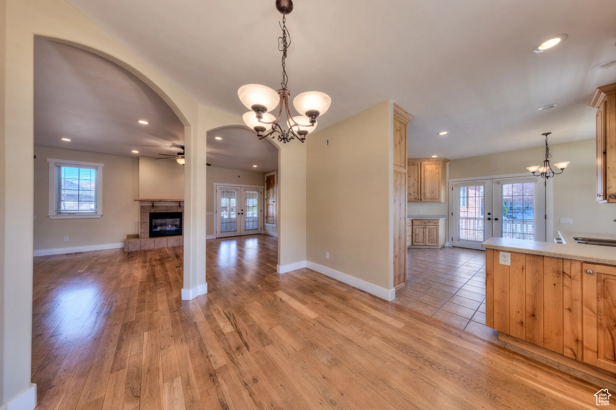 Kitchen featuring french doors, light wood-style flooring, and a fireplace