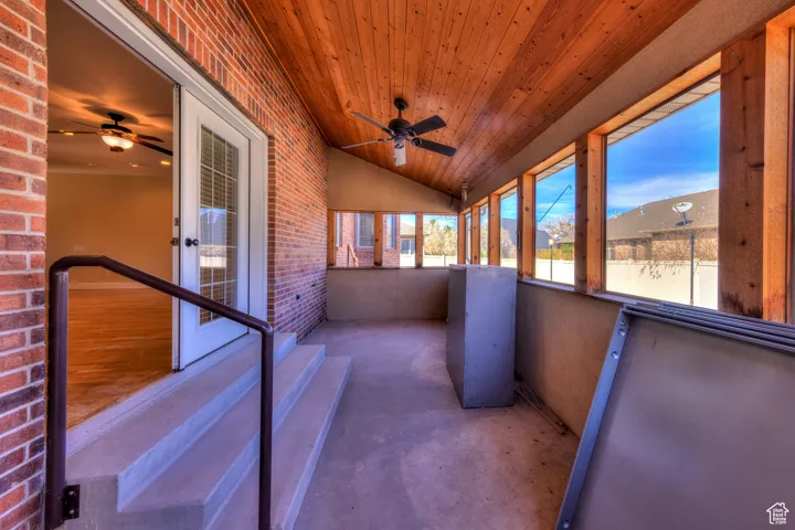 Unfurnished sunroom with a ceiling fan