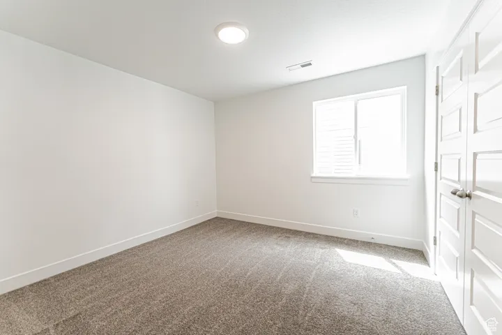 Spare room featuring carpet