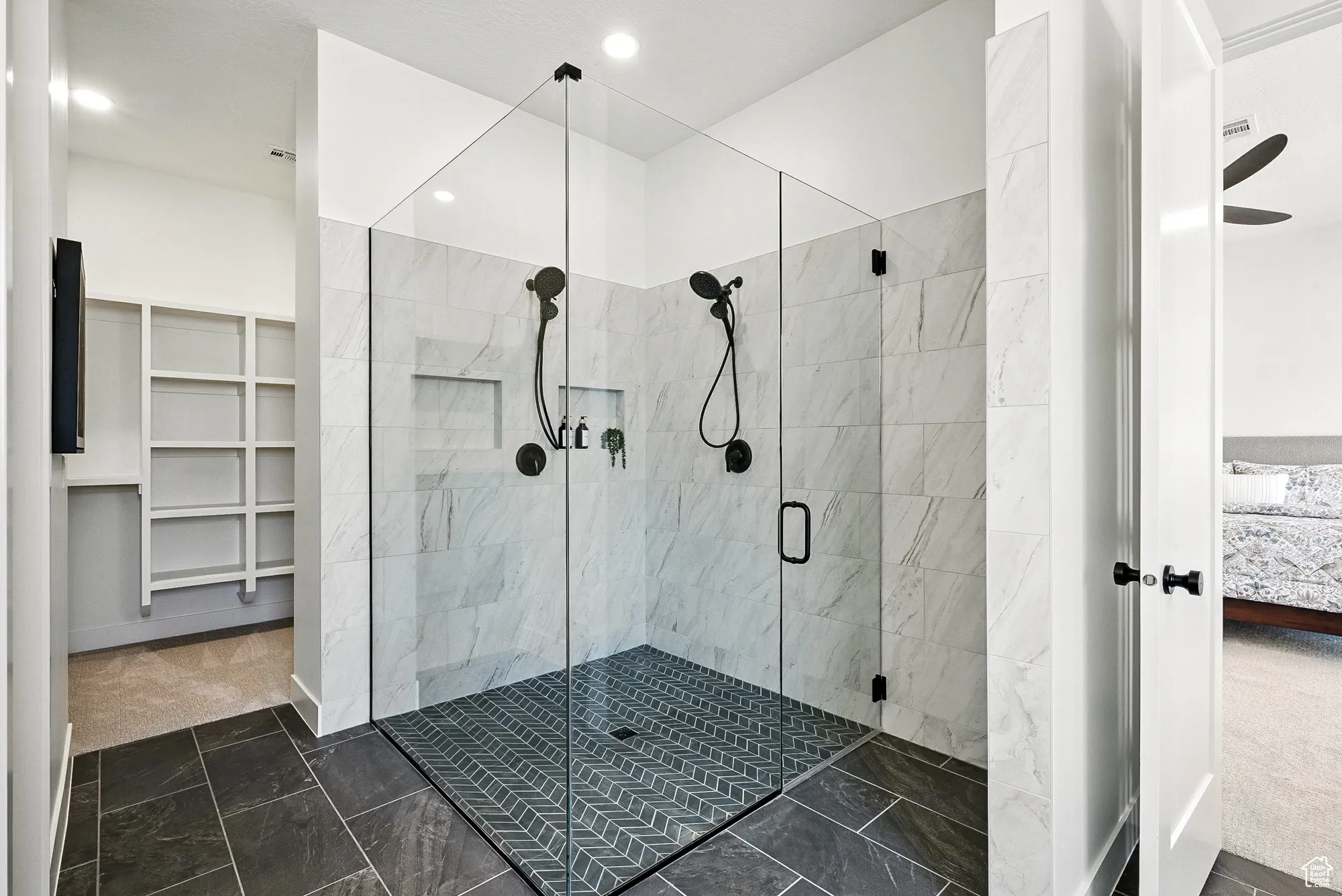 Ensuite bathroom with a stall shower, a spacious closet, and recessed lighting