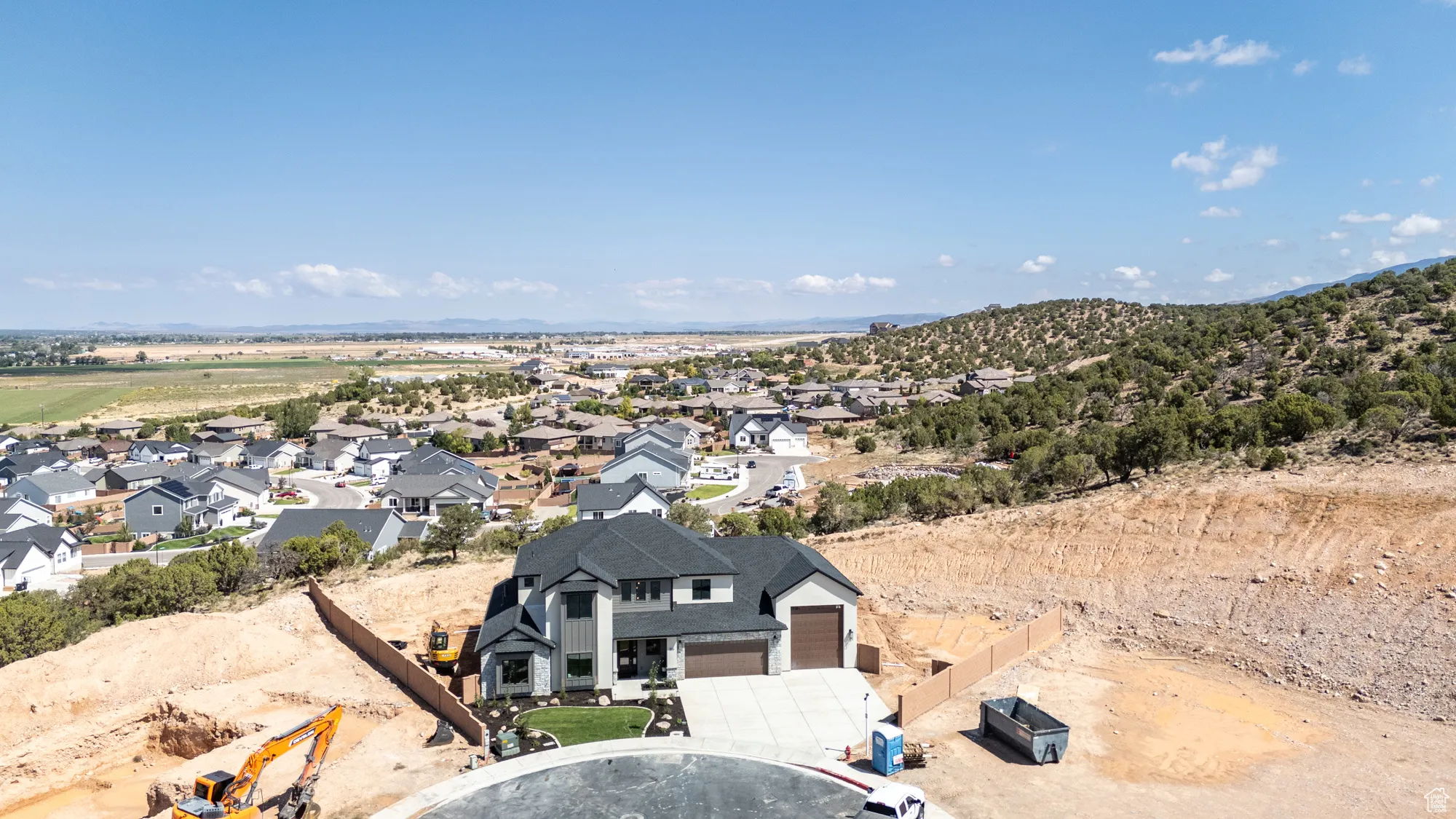Aerial perspective of suburban area featuring a mountain backdrop