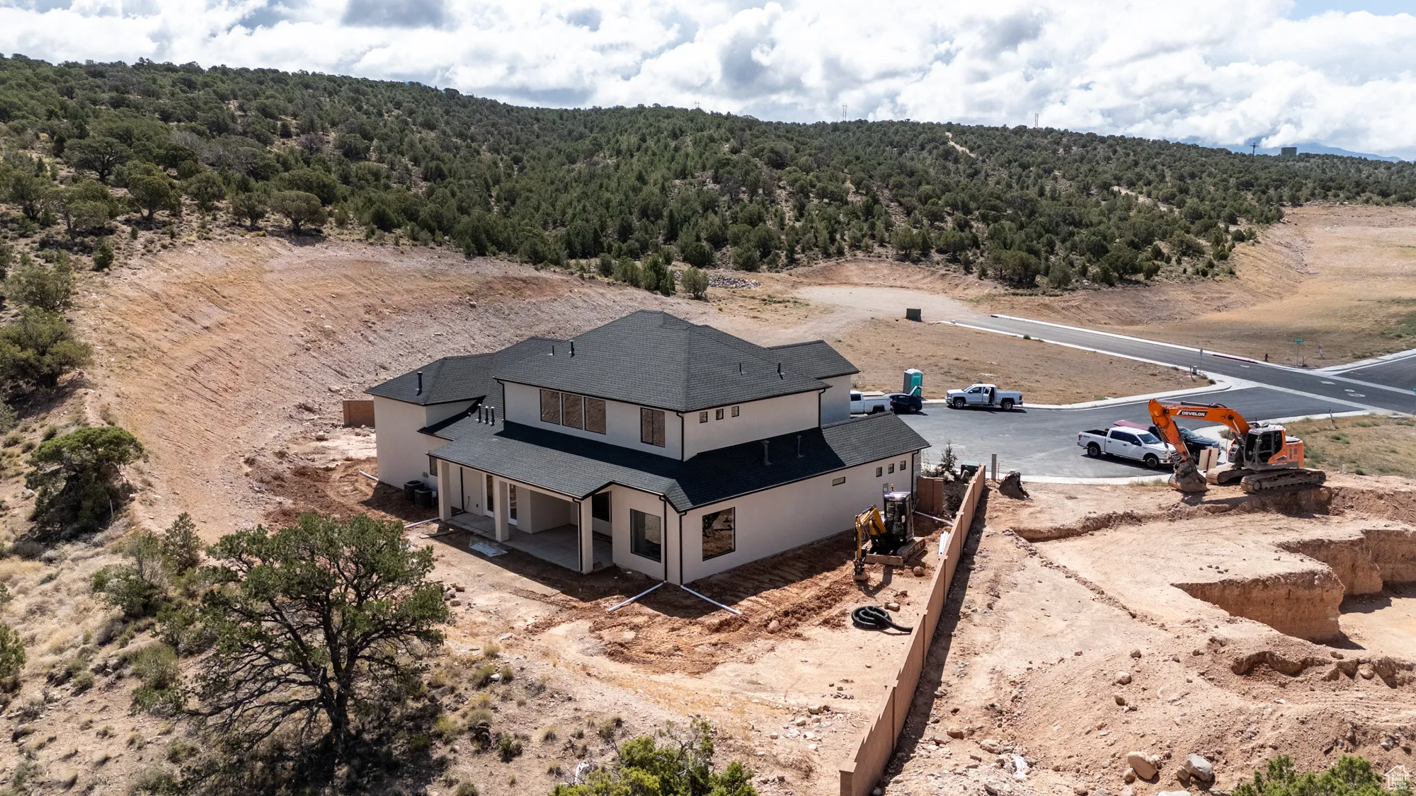 Aerial view of property and surrounding area featuring a heavily wooded area