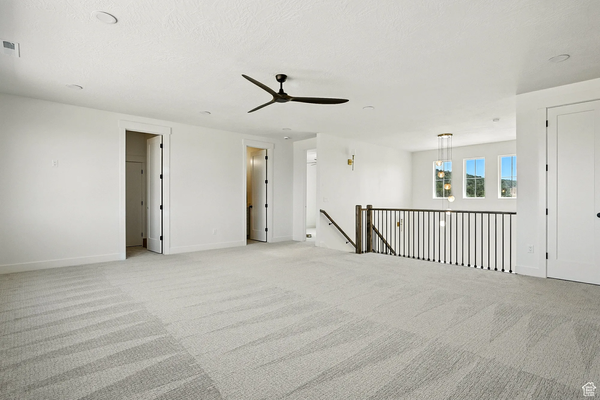 Spare room with carpet floors and a ceiling fan