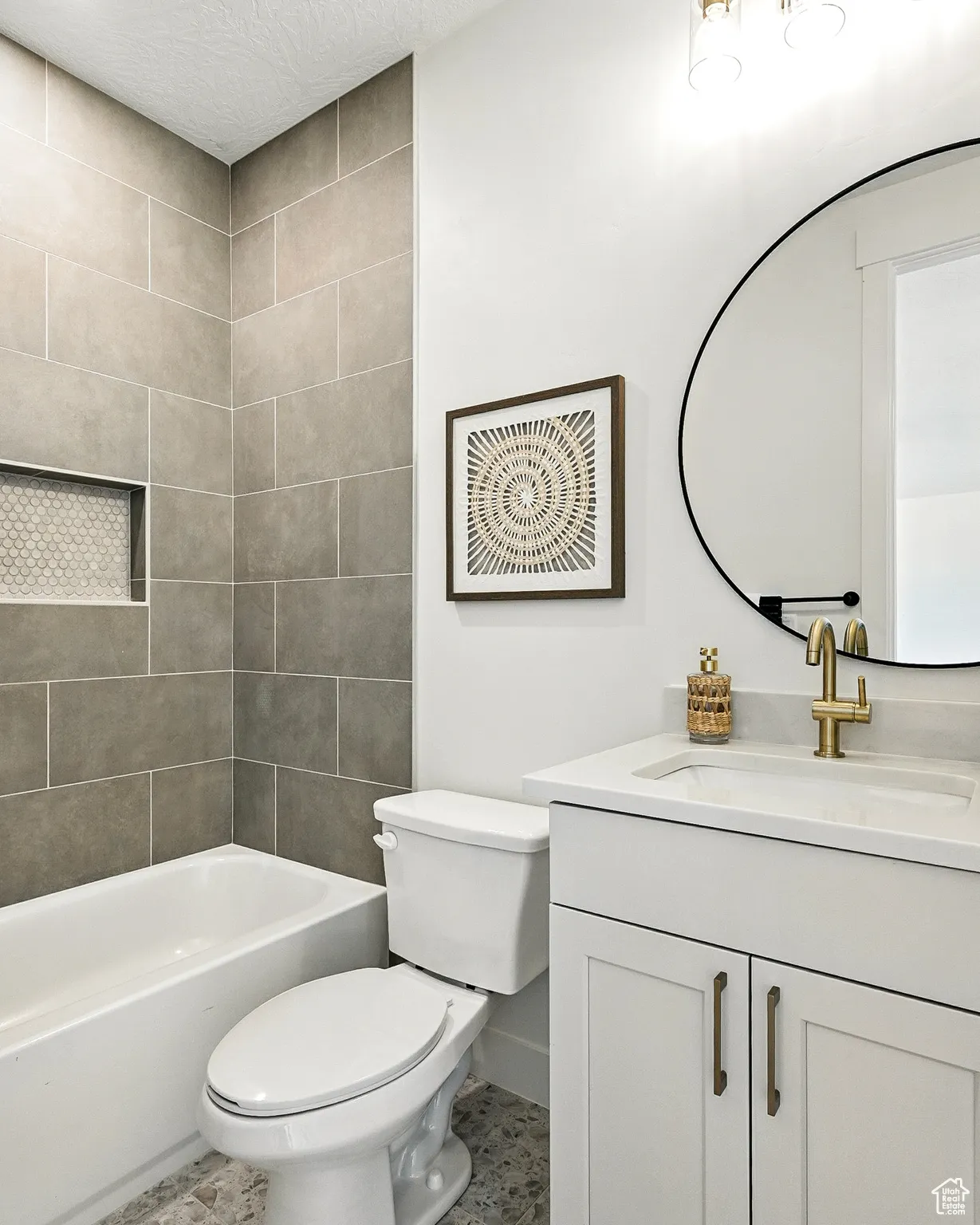 Bathroom with vanity, tub / shower combination, and a textured ceiling