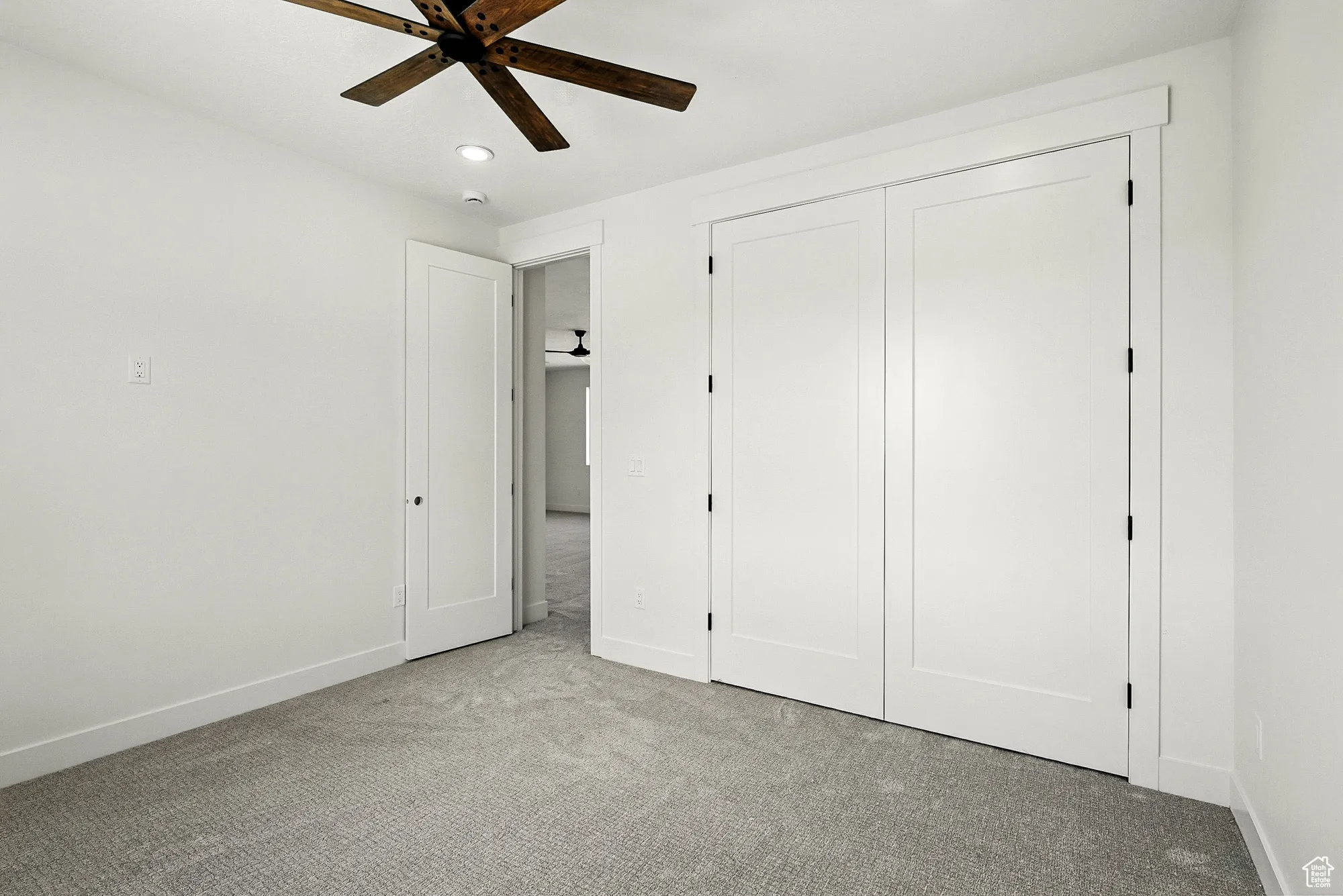 Unfurnished bedroom featuring carpet, recessed lighting, a closet, and ceiling fan