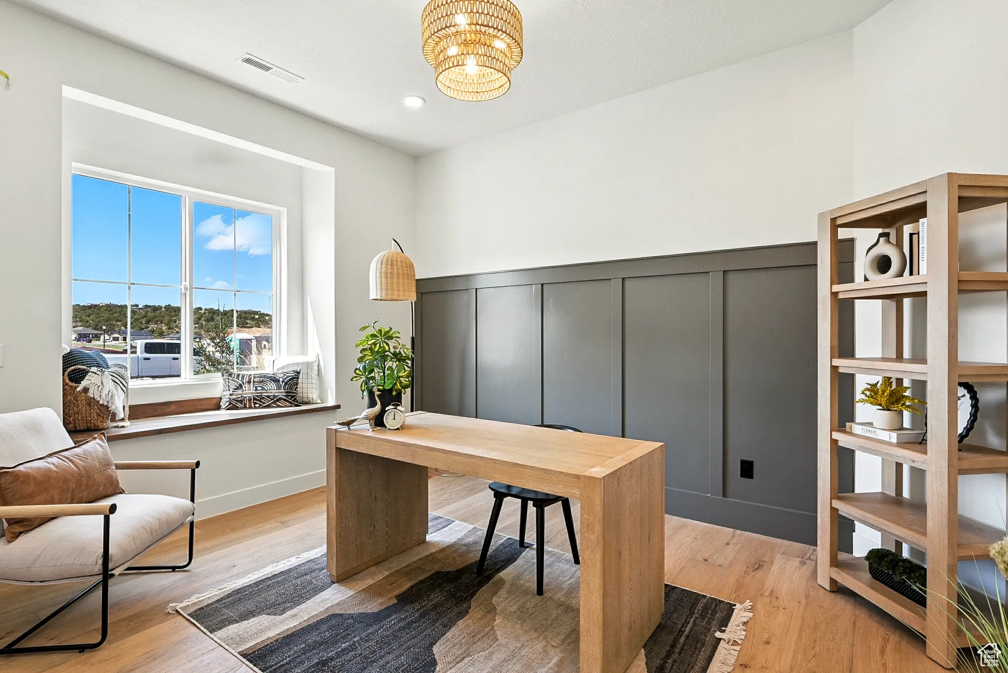 Office featuring light wood-style flooring, a decorative wall, recessed lighting, and a chandelier