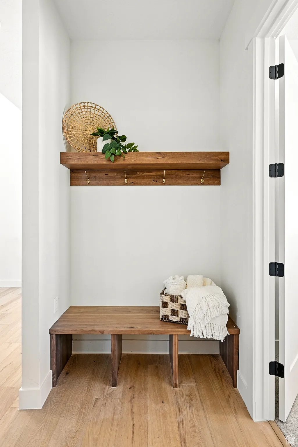 Mudroom with light wood-style flooring and baseboards