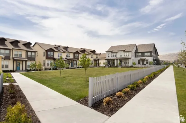 View of property's community with a residential view, fence, and a lawn