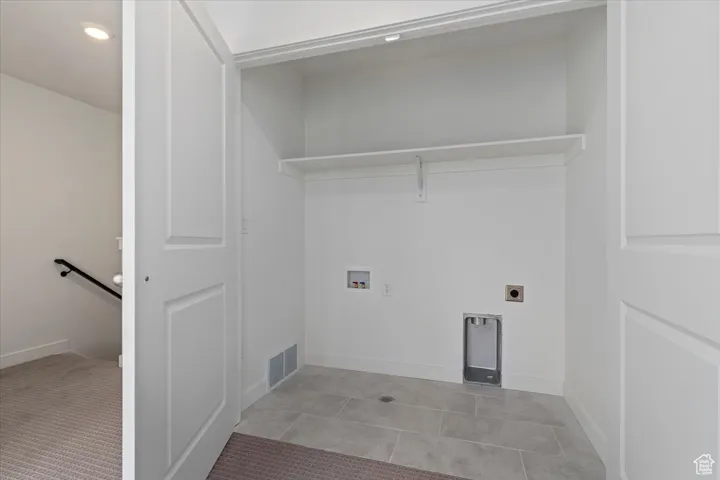 Laundry area with visible vents, hookup for a washing machine, baseboards, laundry area, and electric dryer hookup