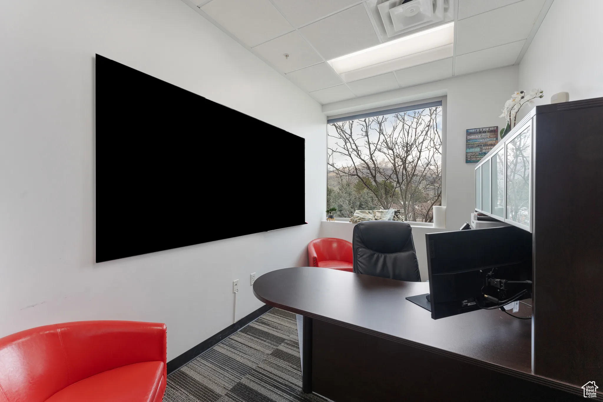 Home office featuring baseboards, carpet flooring, and a paneled ceiling