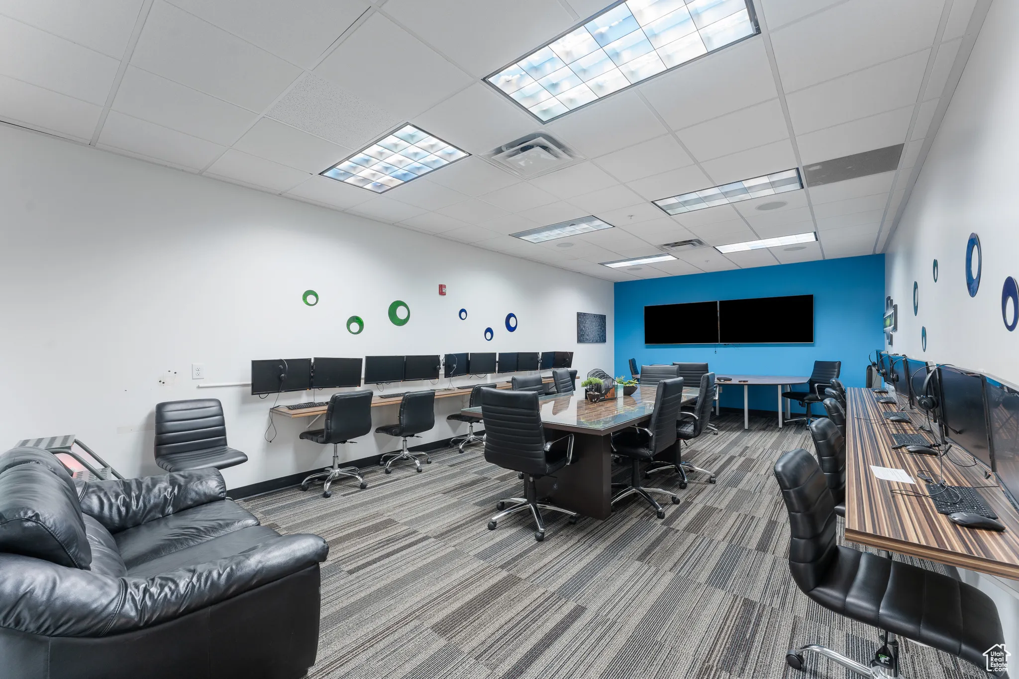 Carpeted office with visible vents and a paneled ceiling