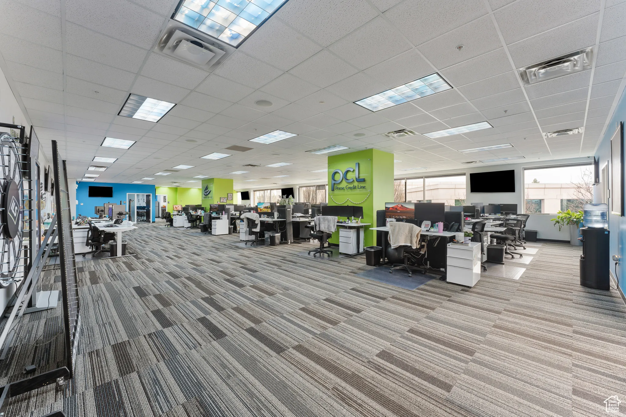 Interior space featuring carpet flooring, a drop ceiling, and visible vents