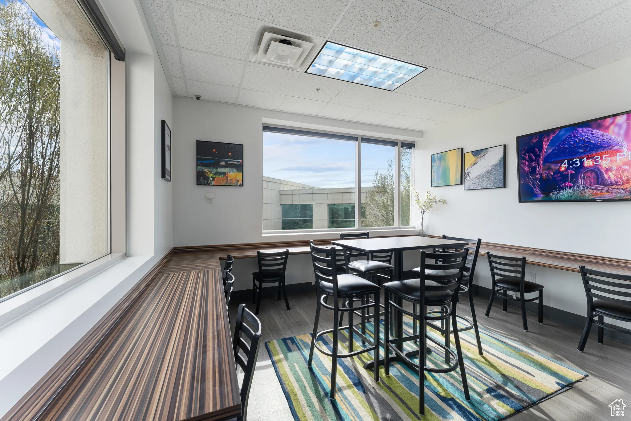 Dining room with wood finished floors and a paneled ceiling