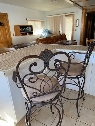 Dining space with light tile patterned floors